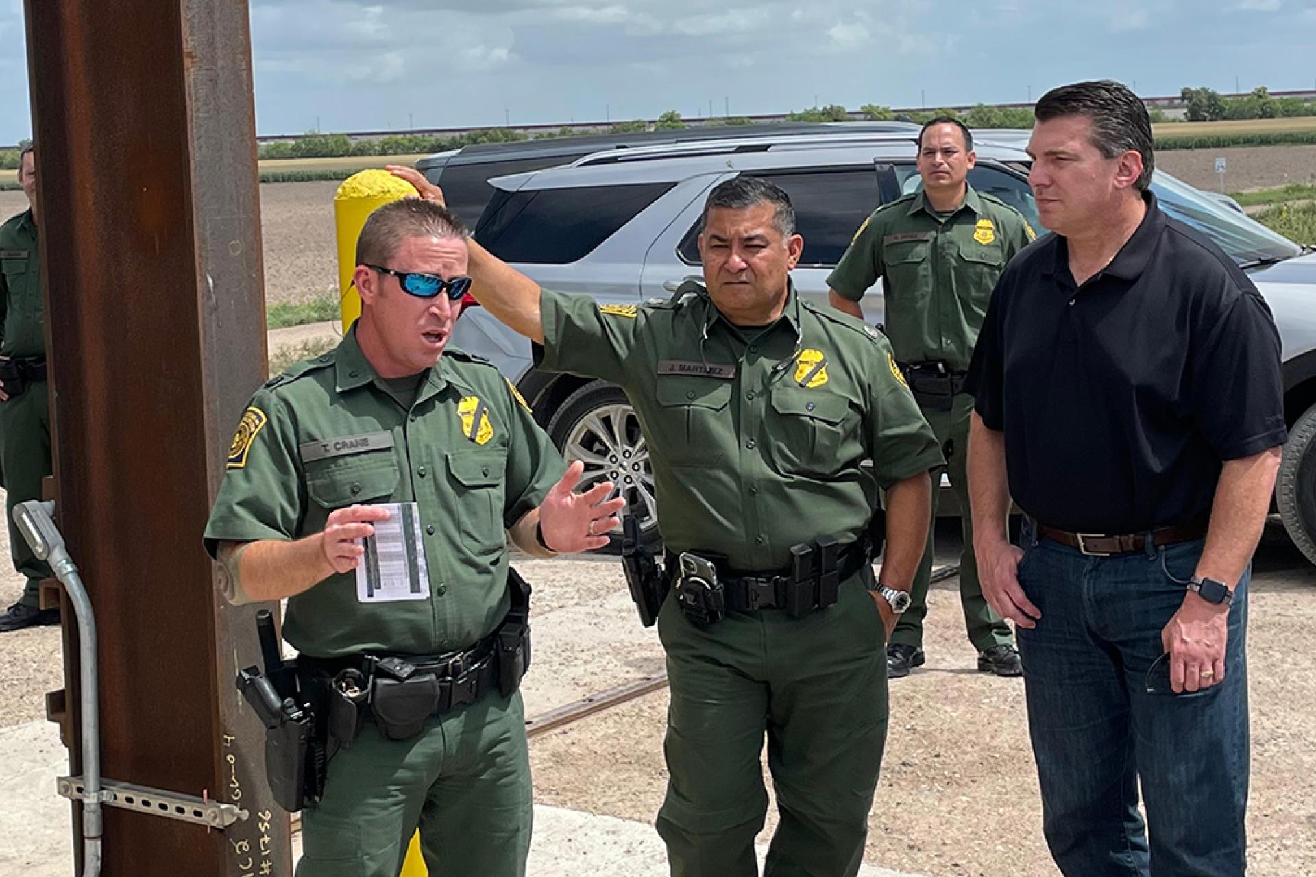 The congressman talking with border patrol agents